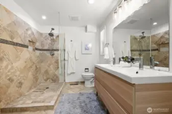 Primary bathroom features a double sink and a walk-in shower.