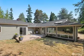 Backyard features a large freshly painted deck and plenty of grass to run around.