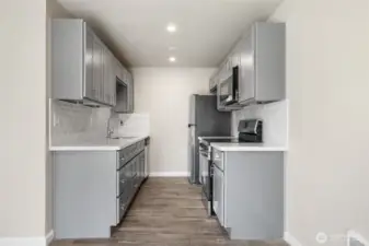 Fully renovated kitchen with new SS appliances, countertops and cabinetry.