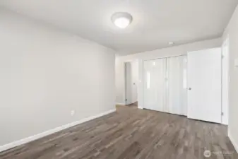 Pass through the living room and into another multi-use room with access to laundry and bathroom.