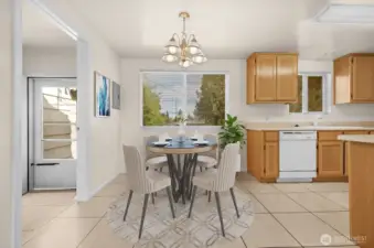 Dining area adjacent to kitchen with access to patio and backyard.