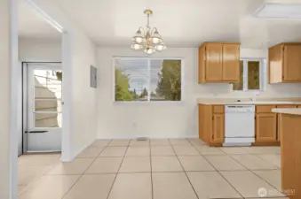 Dining area adjacent to kitchen with access to patio and backyard.