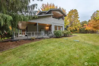 This view from the side shows the generous covered porch and the upstairs covered balcony!