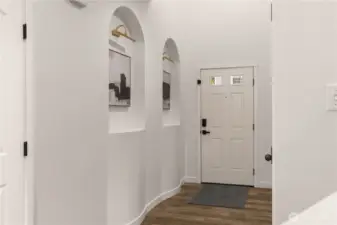 The entryway features art niches adding a personal touch and inviting ambiance.