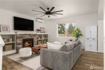 Spacious family room featuring a striking oversized fan and a cozy gas fireplace, perfect for warmth and style.