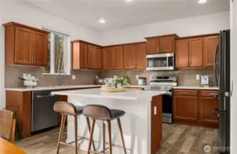 Discover a chef's kitchen featuring a spacious island and pantry, ideal for entertaining guests with style and convenience. Perfect for culinary creativity!