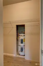 Primary walk in closet, with access to hot water heater.