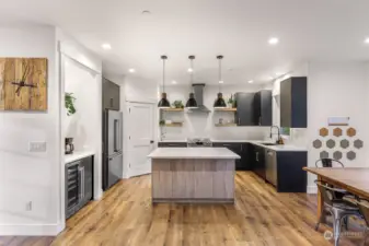 Kitchen features: High Craft locally made custom cabinets, quartz counter tops, open shelving, extra large island with storage on both sides, walk in pantry with built in shelving to maximum organization and a fun coffee/wet bar