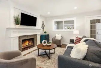 Cozy living room offers additional space to hang out around the gas fireplace.