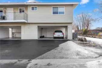 Covered Carport parking w/ deep storage cupboards & closet