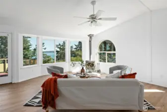 Large living room with expansive views and a wood stove to keep you cozy warm in the winter!