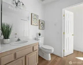 Maint Floor guest bathroom on the main level includes a separate shower attached to the second bedroom.