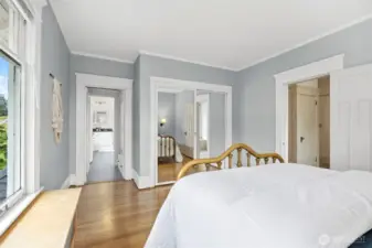 Entry to the bathroom has built-in storage with drawers & clothes hanging rack.