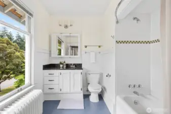 Updated bathroom with original bathtub.