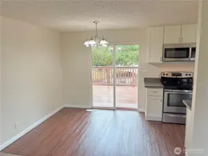 Dining area between the living room and kitchen in this updated split-level at 16312 127th Pl SE, Renton—open flow for entertaining, new flooring and fresh paint in the Cascade neighborhood 98058.