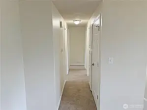 Hallway leading to bedrooms and a full bathroom in this updated split-level at 16312 127th Pl SE, Renton—new flooring, fresh paint, and a functional layout in the Cascade neighborhood 98058.