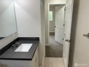 Main-floor full bathroom at 16312 127th Pl SE, Renton—updated, clean finishes and fresh paint; convenient to bedrooms in the Cascade neighborhood 98058.