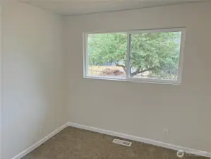 Bedroom #1 in the updated split-level at 16312 127th Pl SE, Renton—bright space with fresh paint, new flooring, and closet storage; flexible for sleeping or a home office in the Cascade neighborhood 98058.