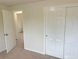 Bedroom #2 in the updated split-level at 16312 127th Pl SE, Renton—fresh paint, new flooring, and closet storage; comfortable secondary bedroom in the Cascade neighborhood 98058.