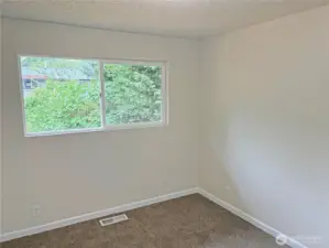 Bedroom #3 in the updated split-level at 16312 127th Pl SE, Renton—bright secondary bedroom with new flooring, fresh paint, and closet storage; situated in the Cascade neighborhood 98058.