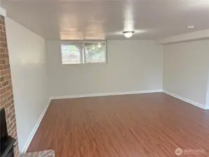 Alternate view of the basement family room in this split-level home—bright, refreshed finishes and room to relax or play in Renton’s Cascade neighborhood.
