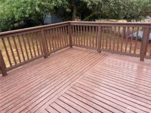 Alternate view of the spacious deck with railings and steps to the wide lawn and garden shed—updated split-level in Renton’s Cascade neighborhood 98058.