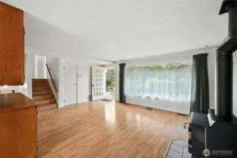 Living room looking to front door and to stairs to bedroom