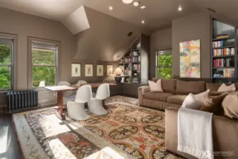Media room with refrigerator, vaulted ceilings, builtins and space for fun and games.