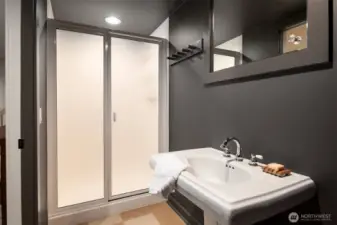 Convenient bathroom with easy access to outdoor spaces, gym, and second laundry room.