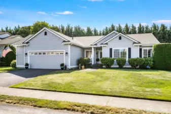 Beautifully maintained front yard with mature plants and lush greenery.