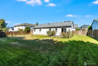 The low maintenance backyard features a sprinkler system.