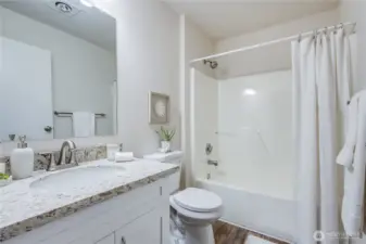 In the hallway you'll find the main bath of the home, also with modern updates and finishes.