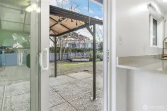 From the kitchen, you can easily step out to the back yard. The covered patio area allows you to enjoy this space year-end.