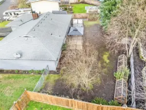 This aerial shot helps you see the back yard a bit better. On the far side of the house is an additional storage shed.
