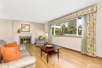 Spacious living room from entry toward wood burning fireplace.