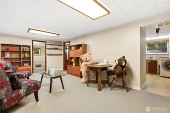 Opposite direction capturing one of 2 large bedrooms downstairs and part of the laundry on right of photo. (Also note covered patio awning is visble through window)