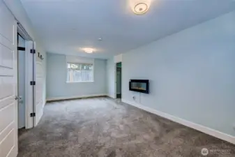 Roomy owner's suite with cozy electric fireplace and two closets!