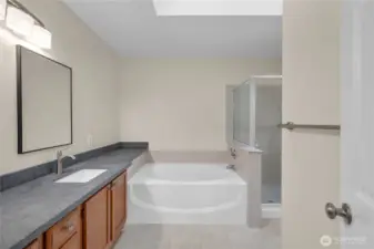 Private en-suite bathroom with a soaking tub and separate shower.