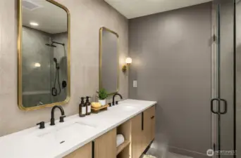 Modern vanity with dual mirrors, high-contrast finishes, and contemporary lighting.
