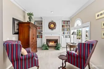 Sitting area in the primary suite complete with cozy gas fireplace #4! Imagine sipping your favorite beverage in the morning or evening from this lovely room.