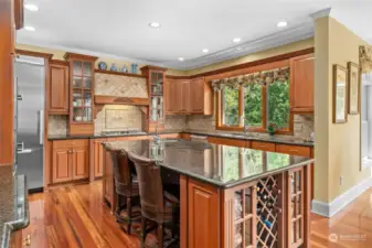 Note the double ovens, walk-in pantry, custom cabinetry and craftsman tiled full-height back splashes that make this home exceptionally livable and welcoming.