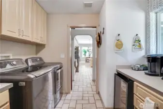large utility room with custom coffee/tea bar  & mini fridge & pull out ironing board