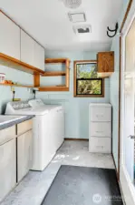 Laundry room with utility sink and ample storage.