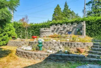 The Castle. Custom built stone garden area with elevated seating. Come and check out the plantings.