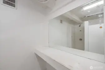 Reflection shows shower stall in lower level 3/4 bath.