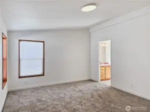 Comfortable primary suite offering privacy, generous closet space, and natural light—an ideal place to unwind.