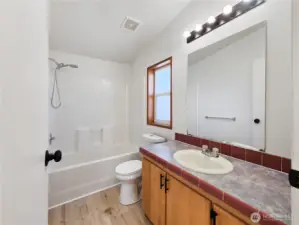 Centrally located full bath with fresh finishes, ideal for guests or family use.