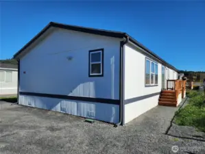 On the back side of the home you have two accesses into the home, one into the dining room through the glass doors and one into the laundry / mud room.