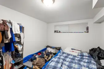 Downstairs bedroom with updated flooring and fresh paint.