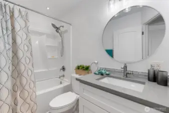 Bathroom with new tub/shower surround. Quartz counter. All fixtures are new.